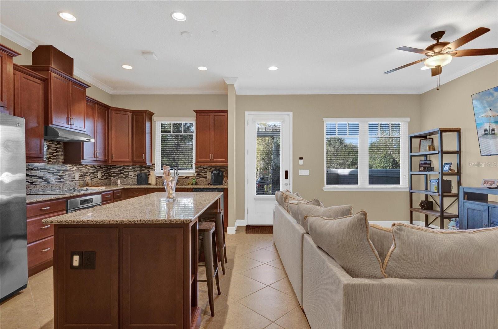 Gourmet kitchen featuring a large center island, granite countertops, and stainless steel appliances.