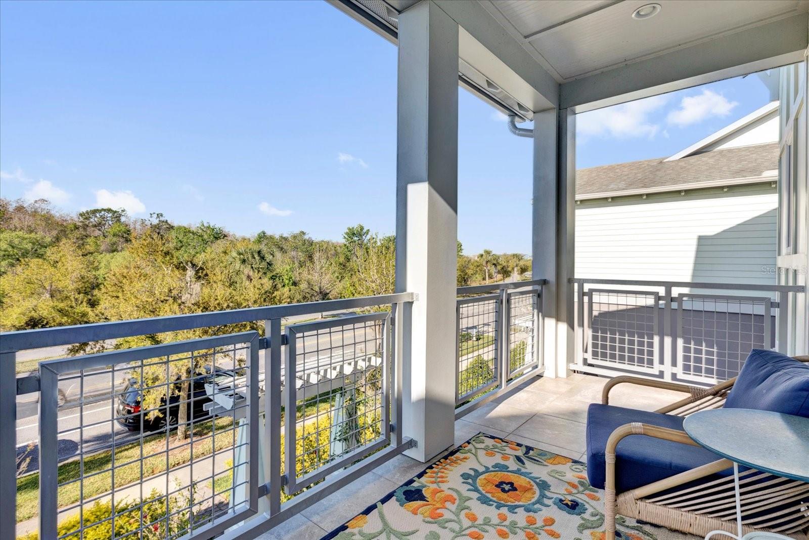 Private covered balcony with seating  a relaxing retreat overlooking the neighborhood.