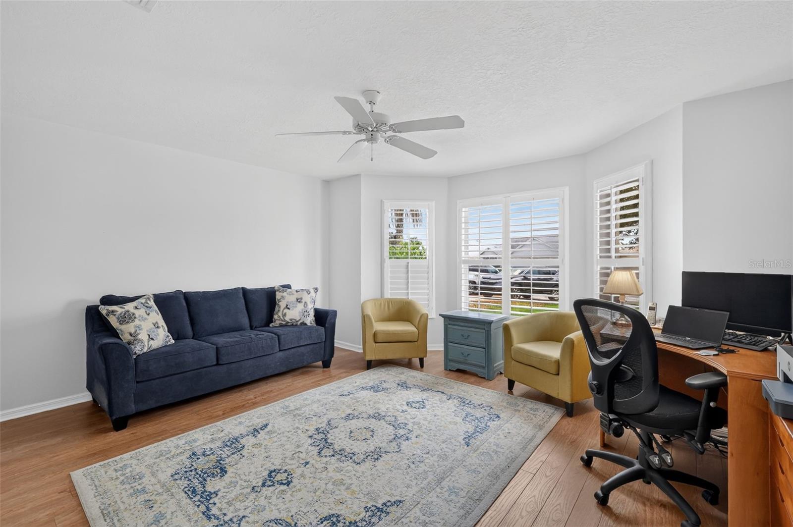 Front guest bedroom with bay window and double door closet