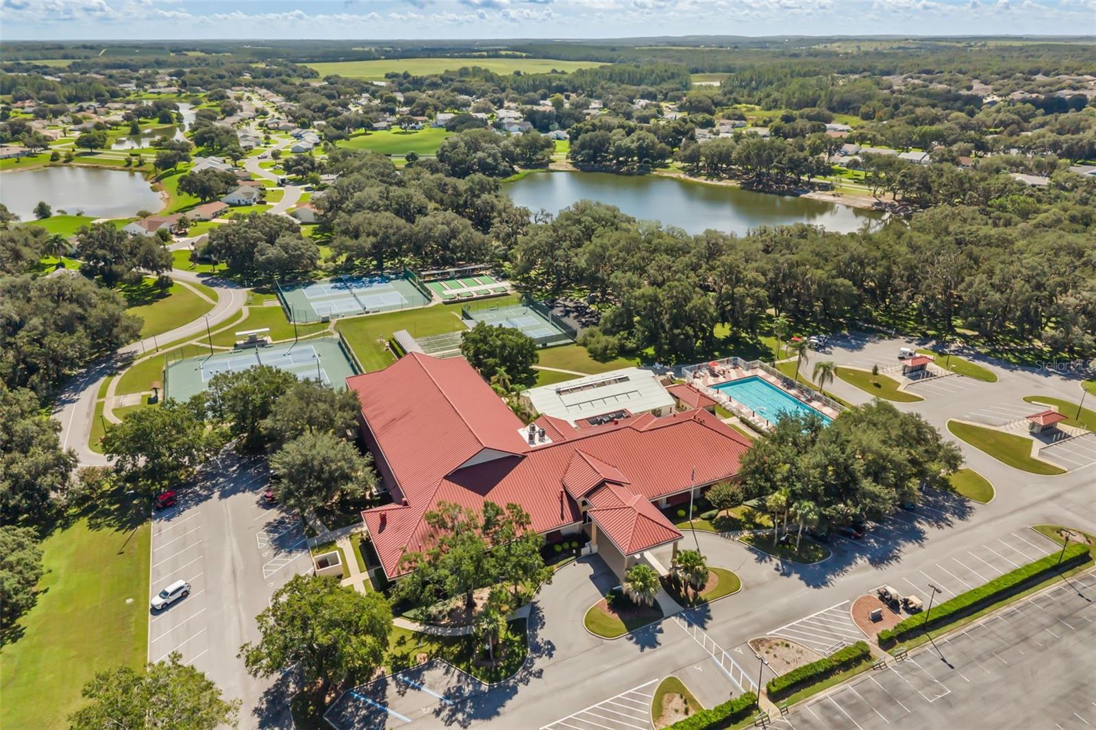 Clubhouse with outdoor pool, tennis, pickle ball and bocce ball courts; lakes for catch & release fishing
