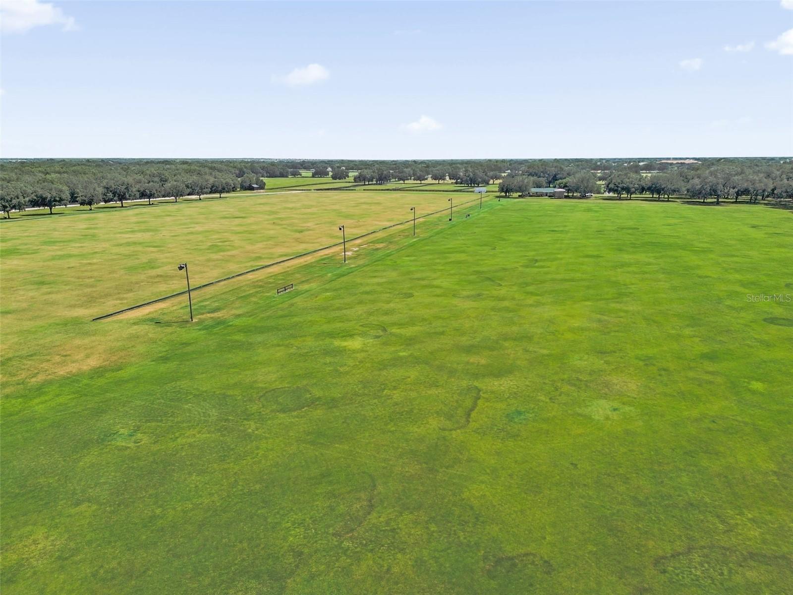 Drone of the polo field behind