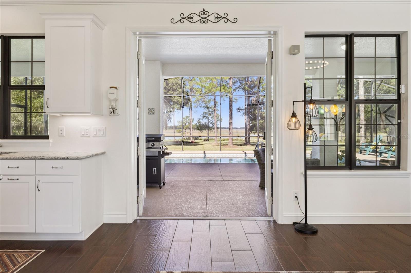 French Doors lead out to the Pool Lanai