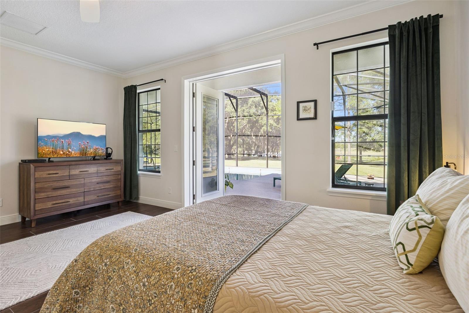 Primary Bedroom with French Doors that lead out to the Pool Lanai