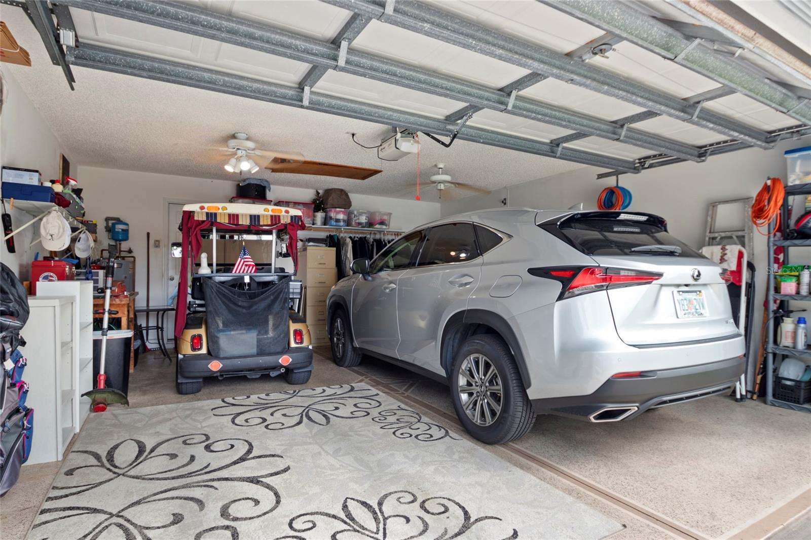 Garage has room for a vehicle and two golf carts.