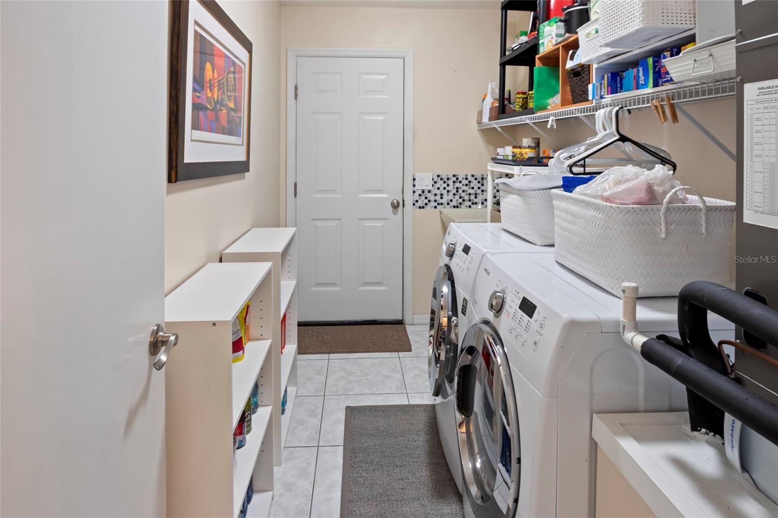 Inside Laundry with storage.