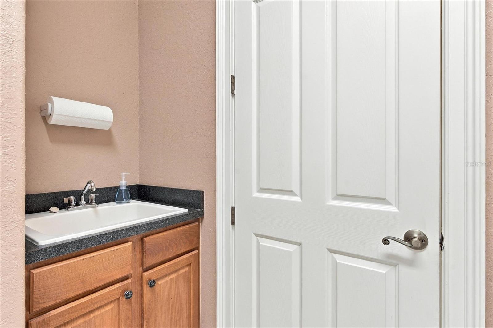 Laundry room features a sink for convenient clean up!