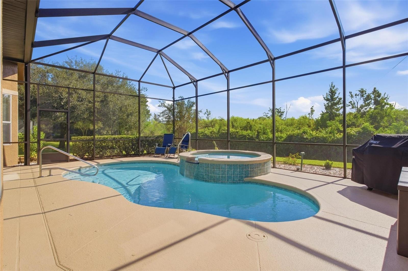 Beautiful view of outside heated pool and spa.