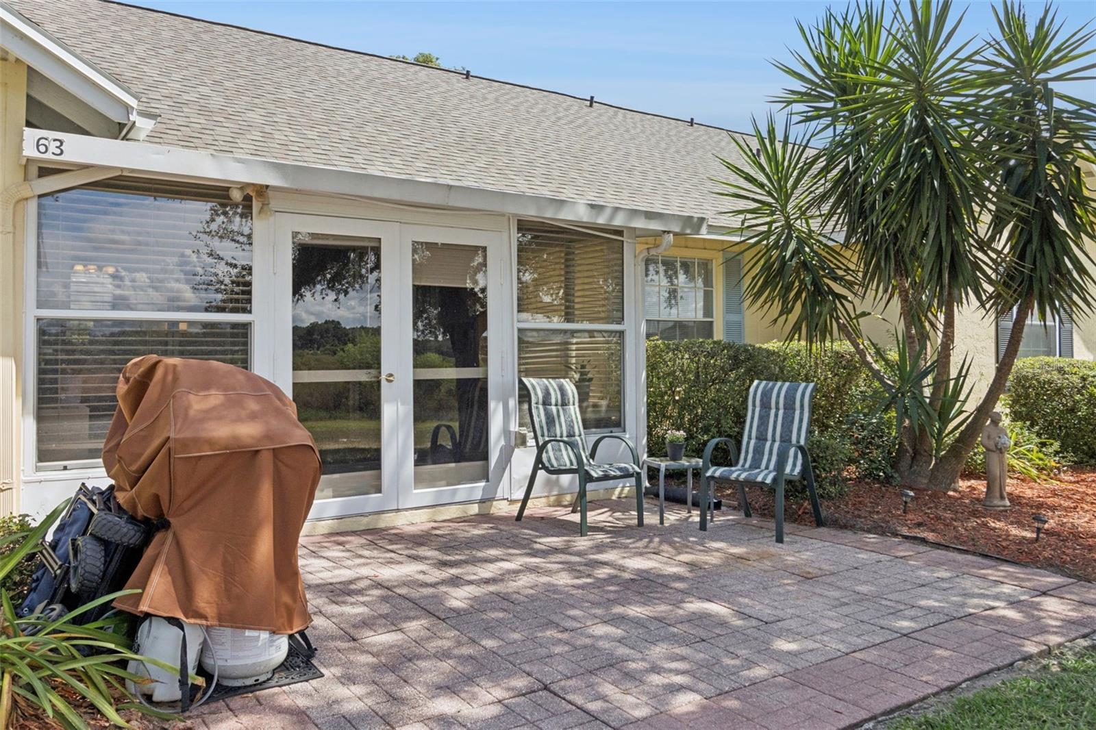 Fabulous Florida foliage flanks the oversized paver patio. Fabulous Florida foliage flanks the oversized paver patio.