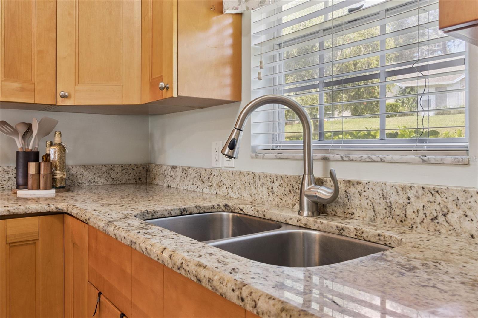 Culinary hosts appreciate the 42" cabinets to the ceiling, pull-out shelves, lazy Susan, and window that brings in natural sunlight over the deep, double kitchen sink. Culinary hosts appreciate the 42" cabinets to the ceiling, pull-out shelves, lazy Susan, and window that brings in natural sunlight over the deep, double kitchen sink.