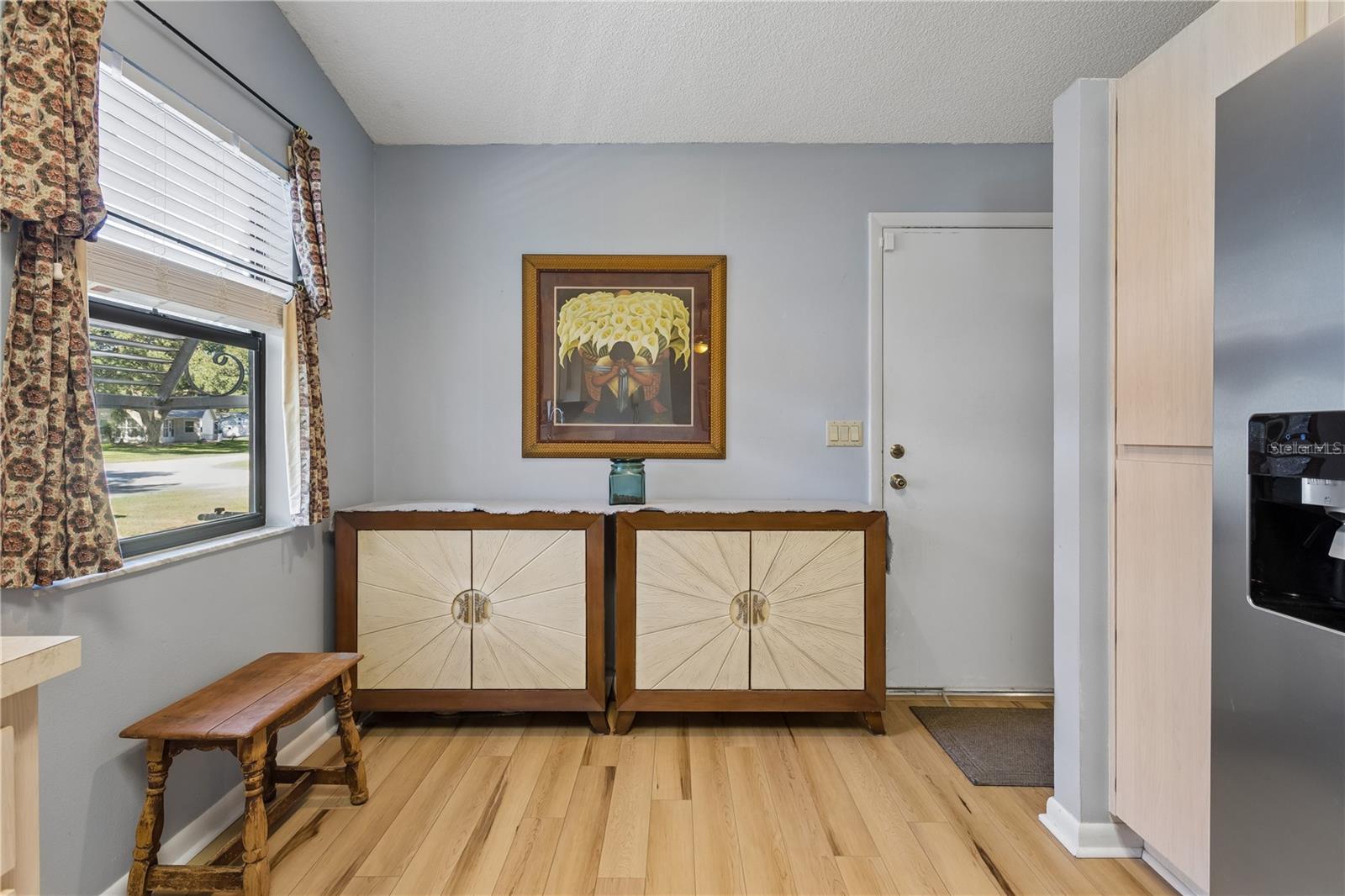 Entry from the living room into the kitchen.  Door leads to the garage.