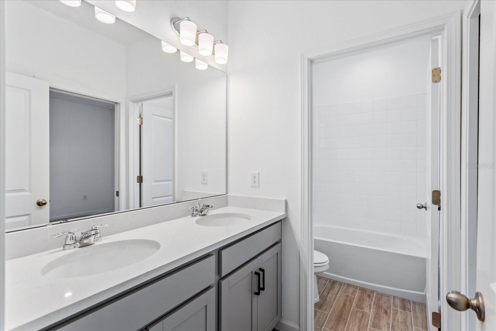 The sample photos included are of the model home and are meant to showcase the craftsmanship and design quality.
