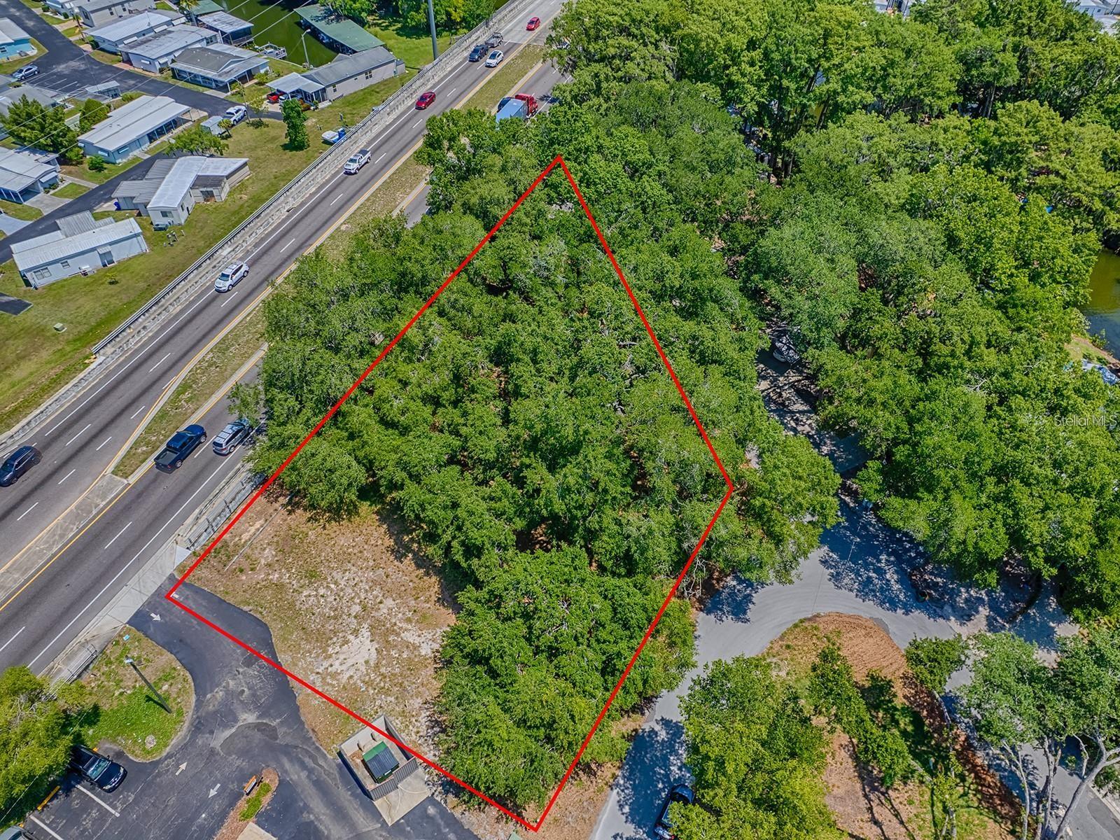 Aerial view of Lion Lane 0.59 acre of vacant land prominently situated along the heavily traveled, 4 lane divided highway State Road 19.
