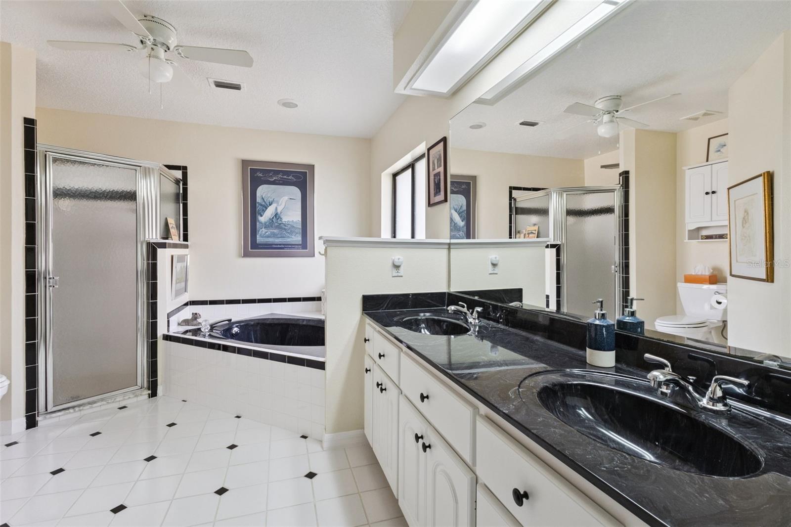 PRIMARY EN SUITE has DUAL SINKS, SOAKER TUB & WALK-IN SHOWER.