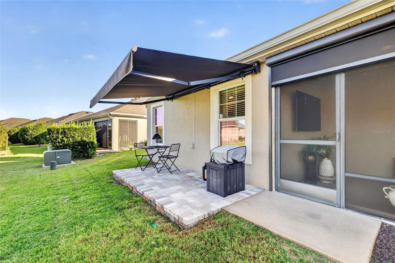 Side Paver Patio with Remote-Controlled Awning