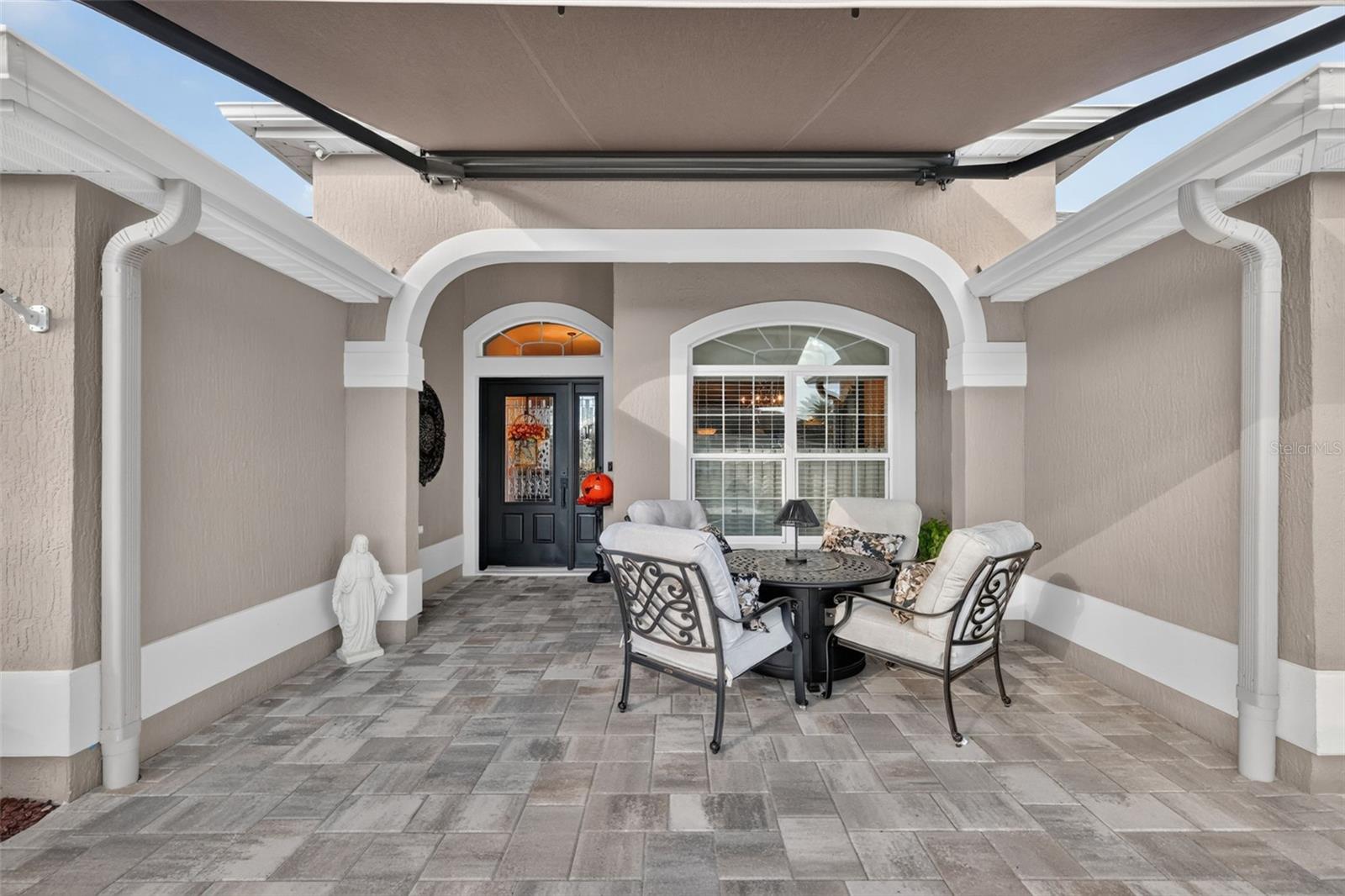 Front Entry with Paver Patio and Remote-Controlled Awning Front Entry with Paver Patio and Remote-Controlled Awning