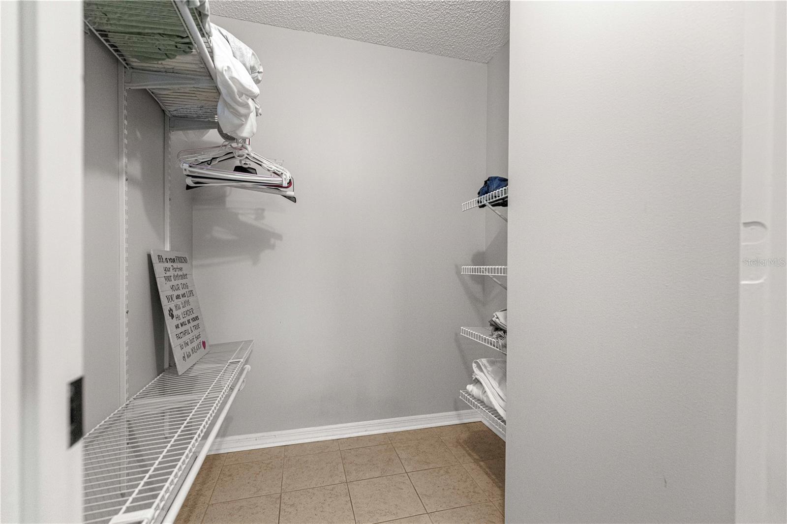 WALK IN CLOSET OF PRIMARY BEDROOM
