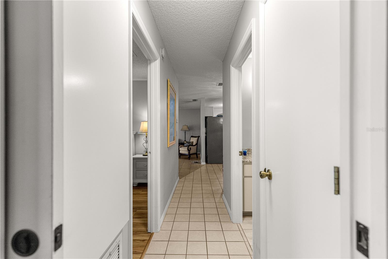 TILED HALLWAY CENTRAL LIVING AREA FROM BEDROOMS