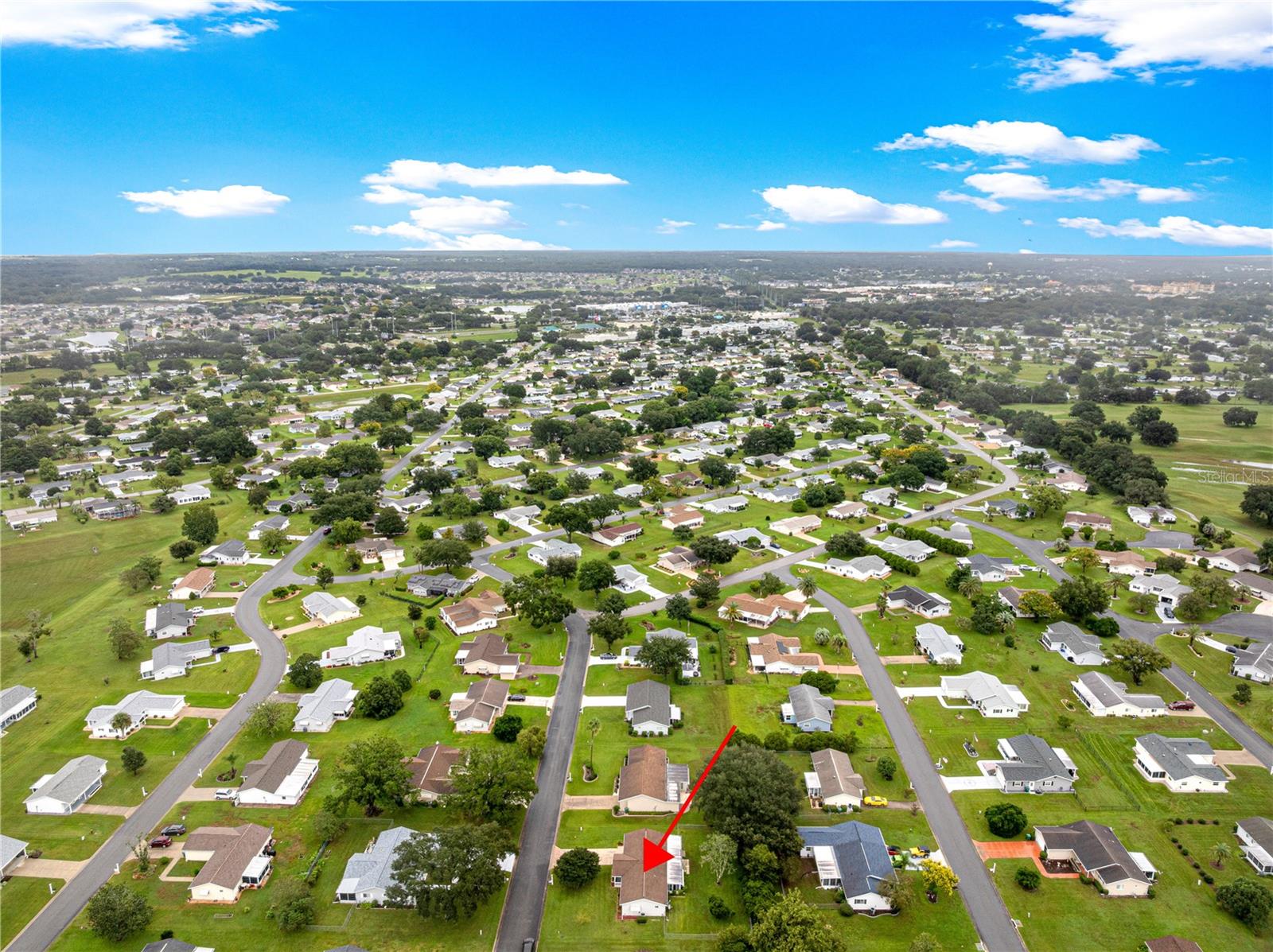 AERIAL OF HOUSE AND SURROUNDING HOMES IN COMMUNITY