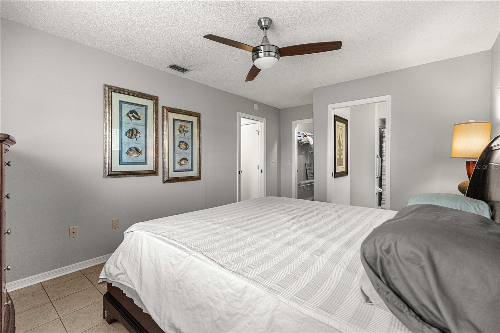 PRIMARY BEDROOM, WITH MODERN FAN AND TILED FLOORS