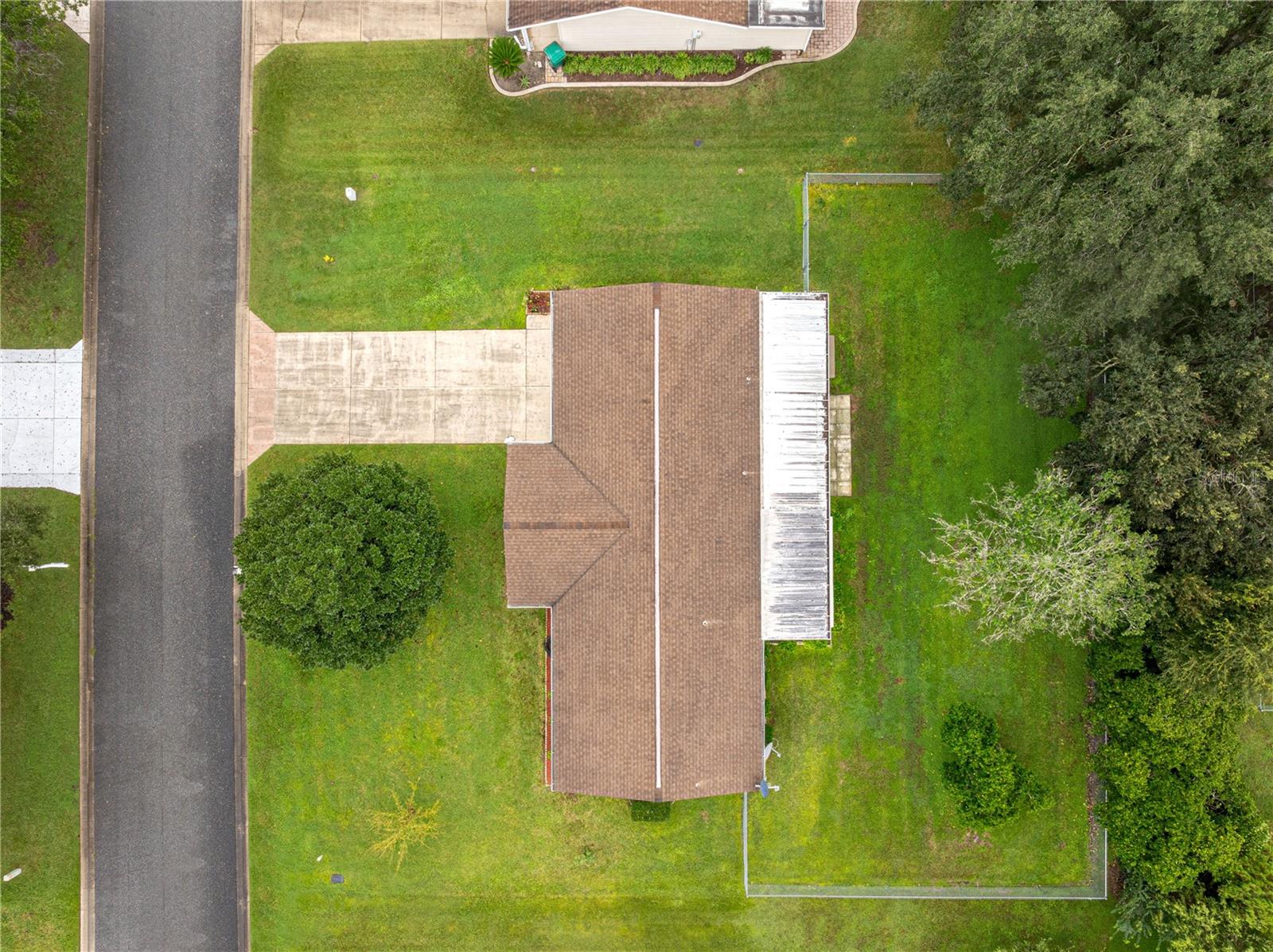 AERIAL OF THIS HOUSE SHOWING THE ROOF AND THE FENCED IN YARD