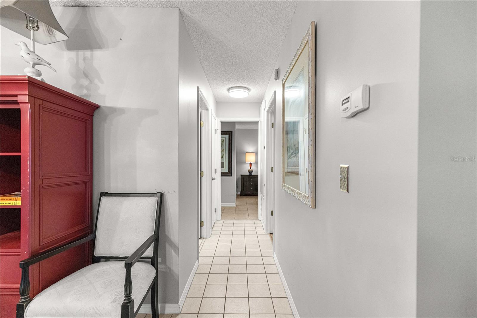 TILED HALLWAY TO BEDROOMS FROM DINING AREA