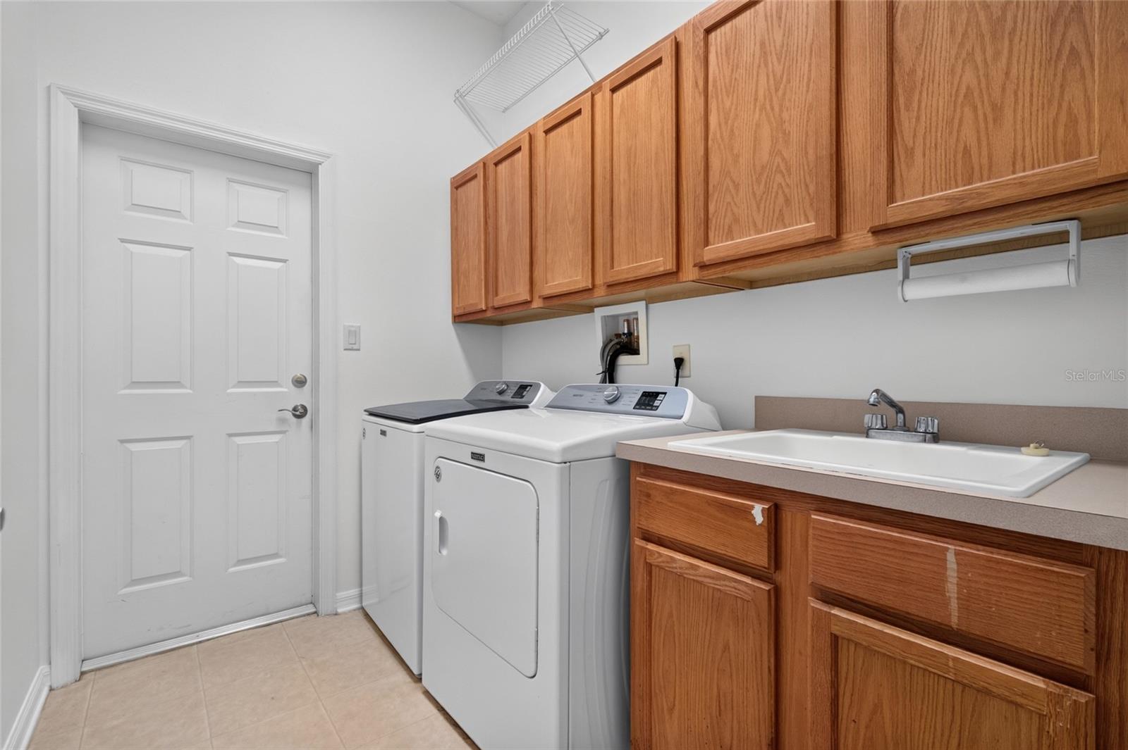 LAUNDTY ROOM WITH WASH SINK AND CABINETS