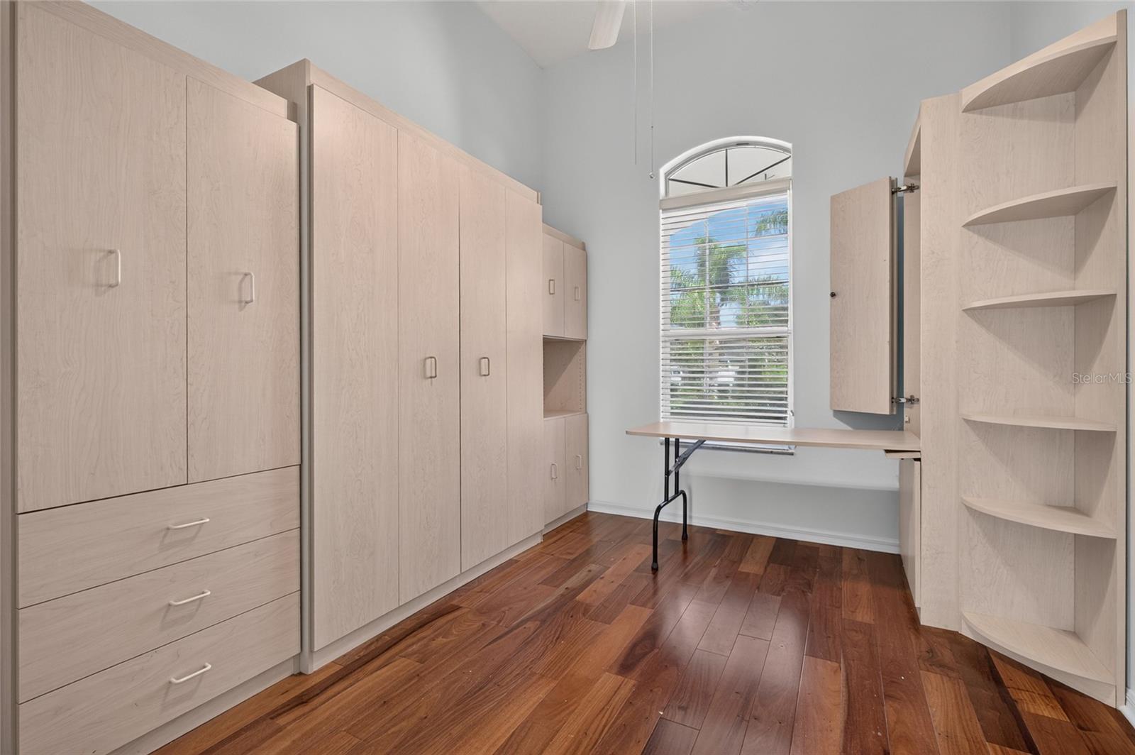 THIRD BEDROOM/OFFICE. FUNCTION AT IT BEST CUSTOM BUILT IN. MURPHY  BED, DROP DOWN DESK, AND STORGE CLOSET AND DRAWERS.
