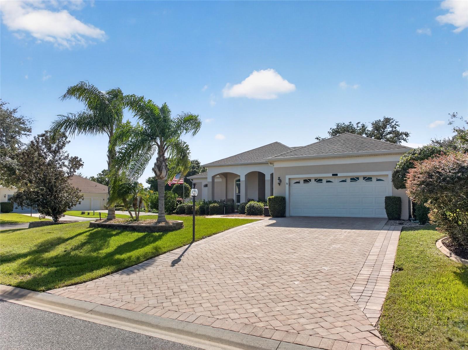 SHE IS A BEAUTY. CORNER LOT, PALM TREES, BRICK PAVER DRIVEWAY