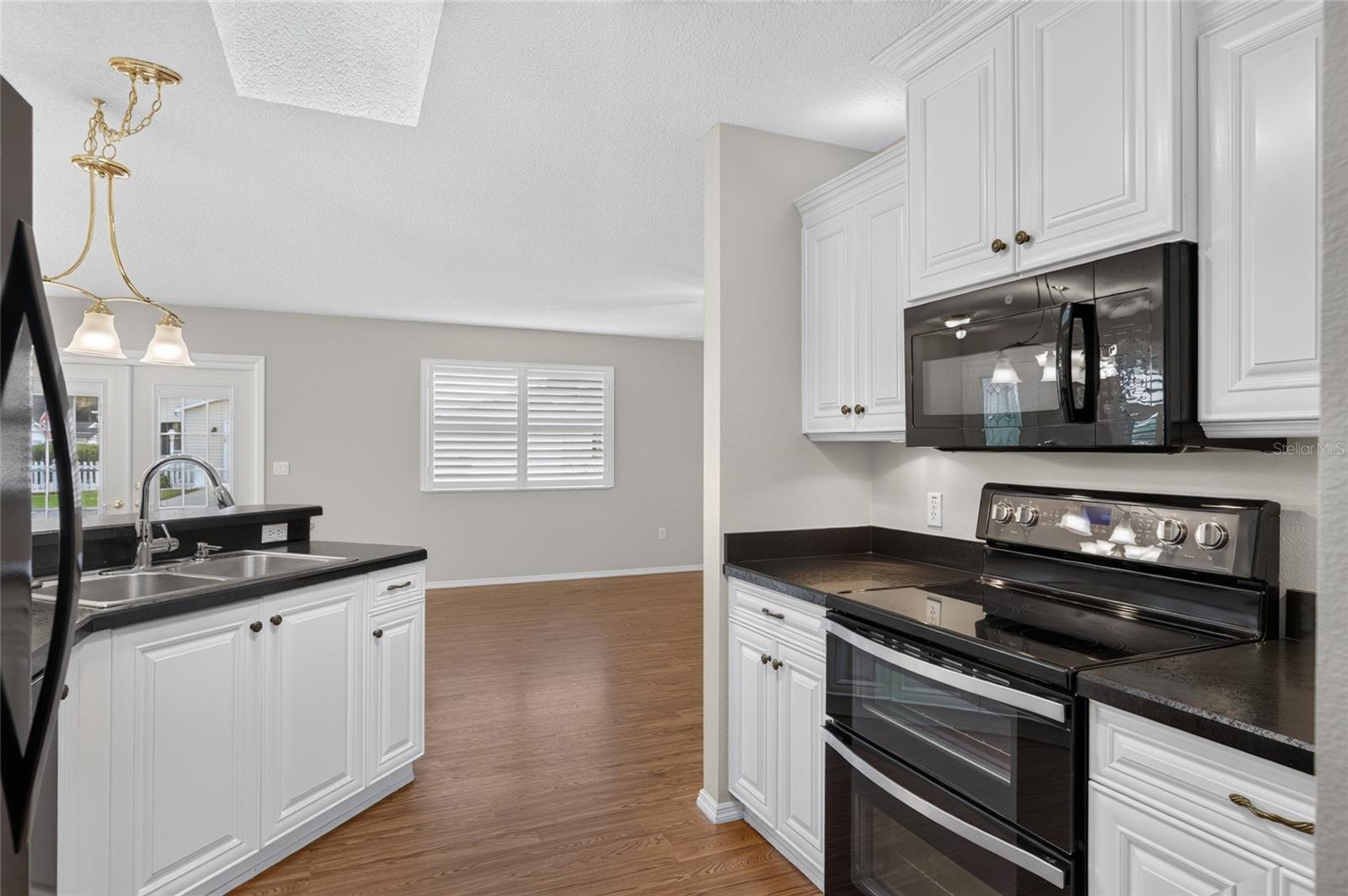 KITCHEN - SKYLIGHT brings natural light into the workspace, with a view through to the living/dining area.