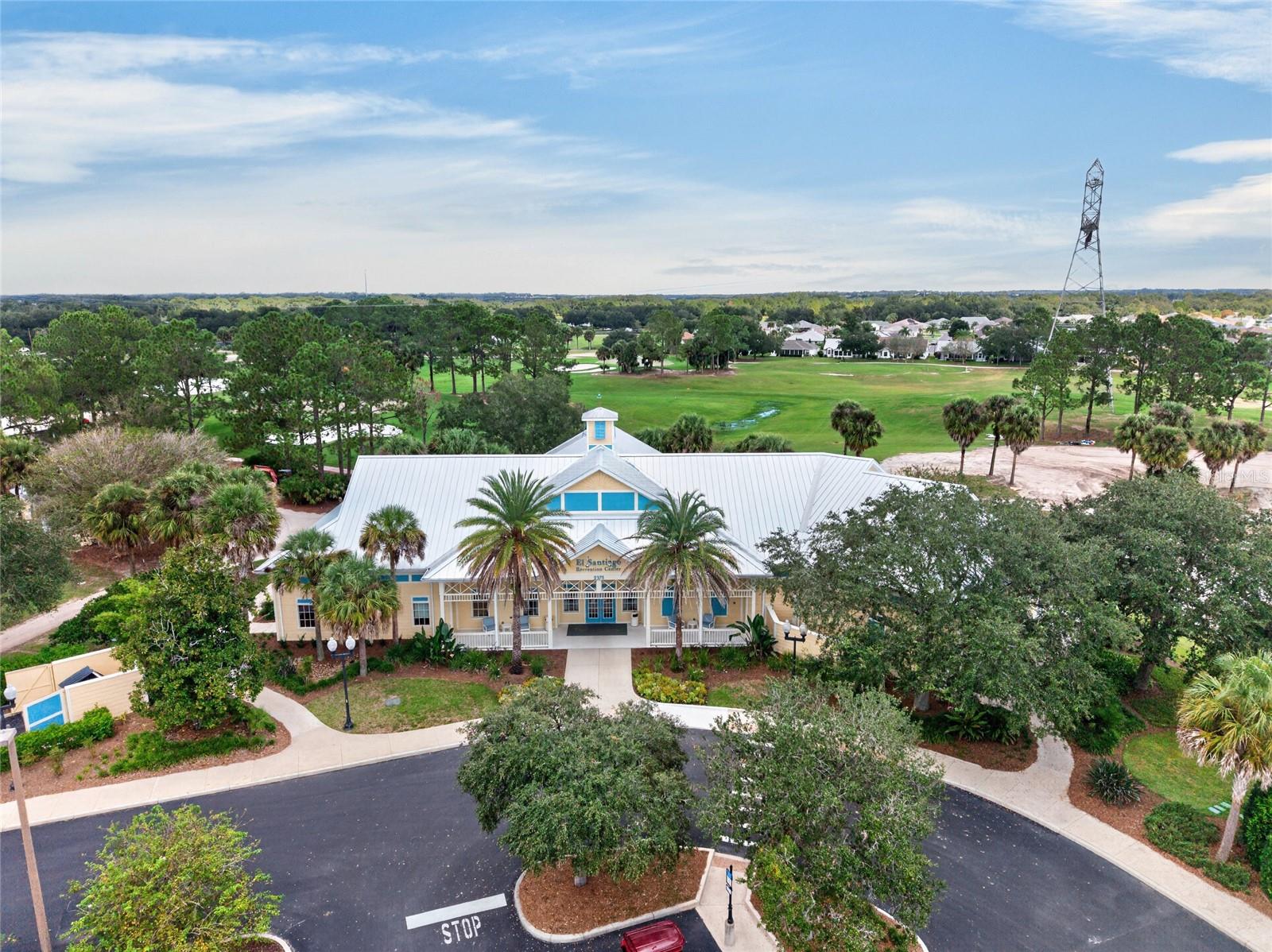 AERIAL VIEW of EL SANTIAGO RECREATION CENTER - Covered entry and parking area, with view of El Diablo executive golf course behind the building.