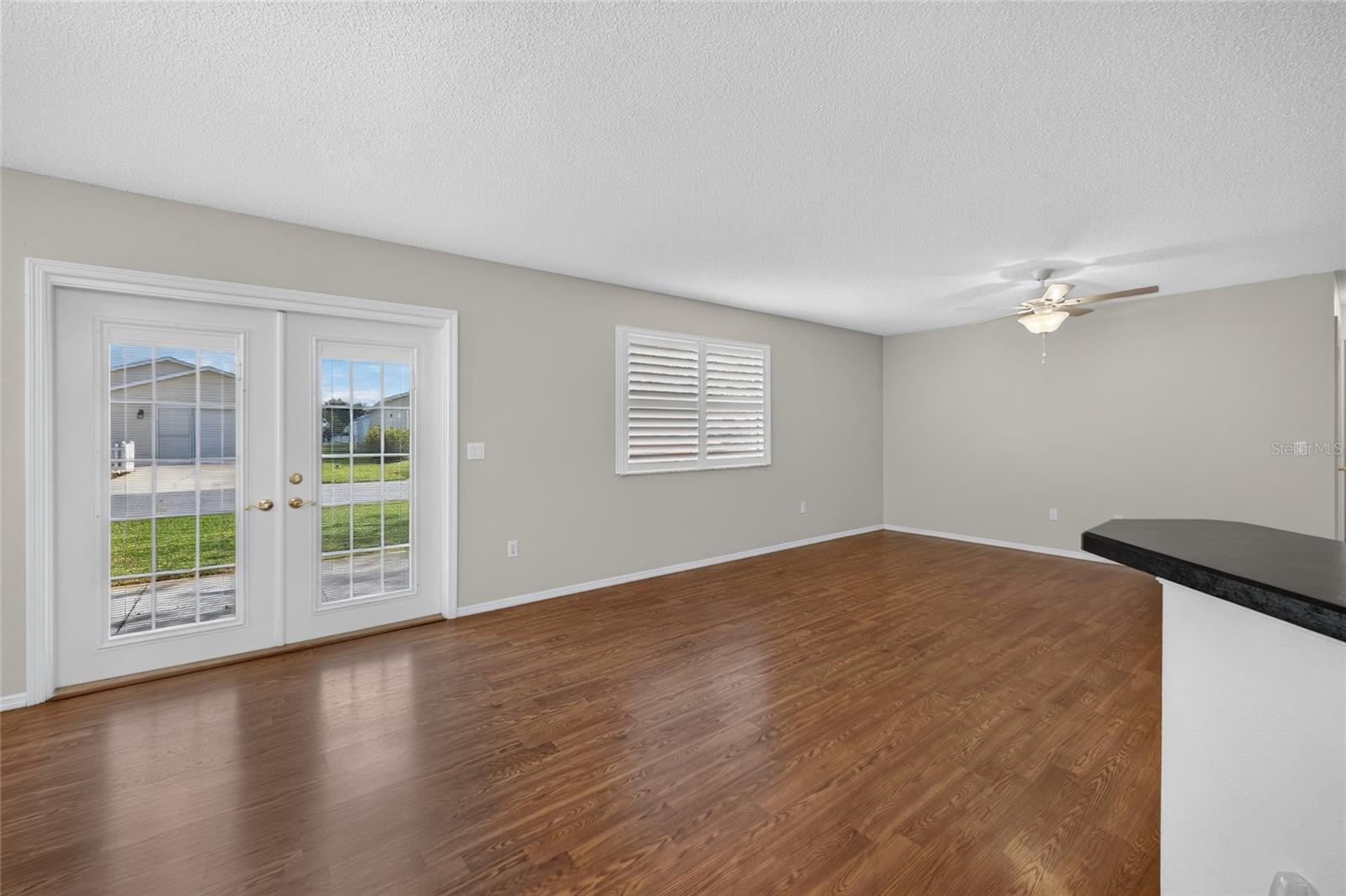 DINING/LIVING ROOMS - Freshly painted walls in a neutral palette provide a simple backdrop for the main living space.