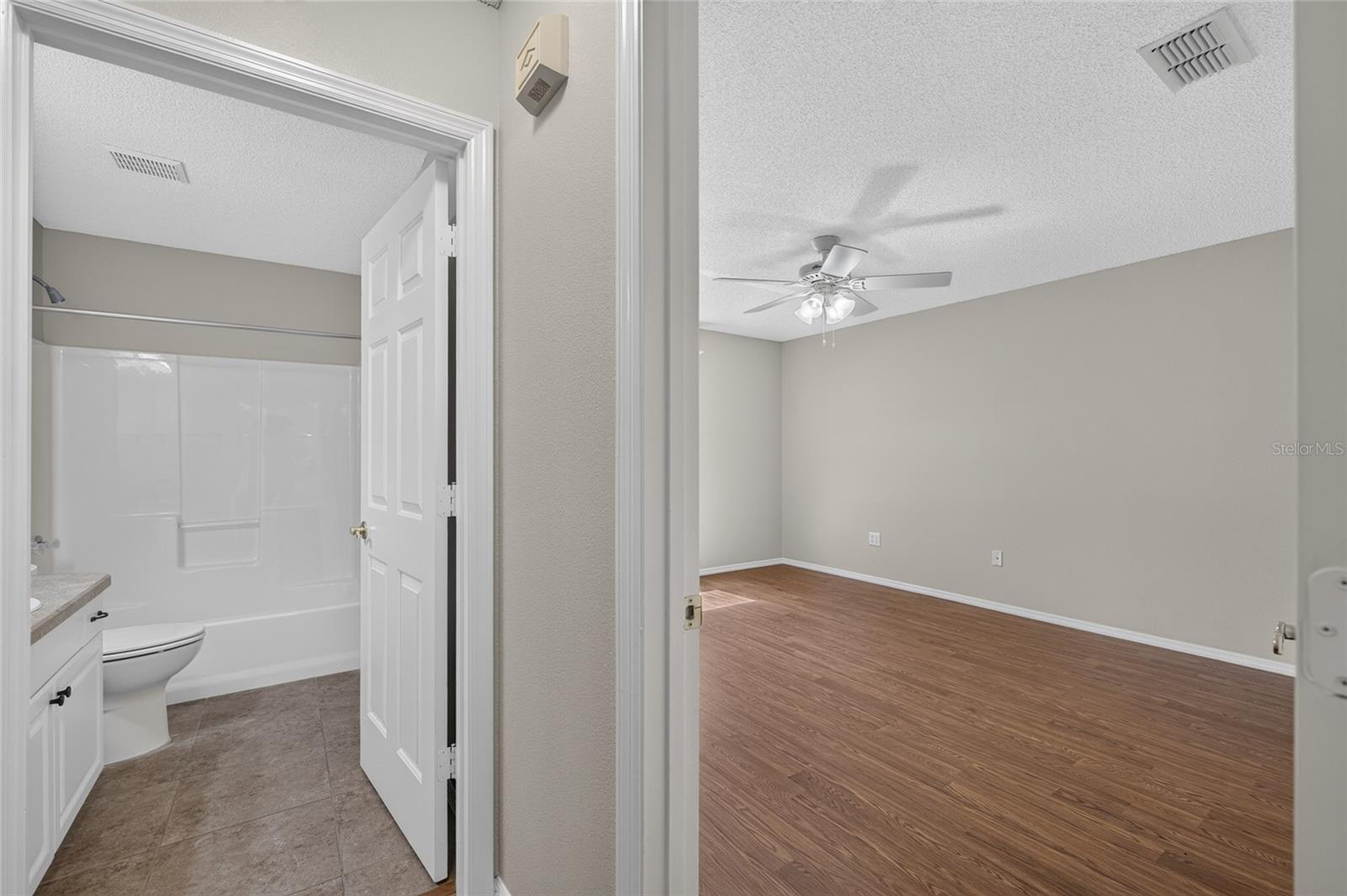 View of HALLWAY to rear of villa - PRIMARY BEDROOM doorway (R) and BATHROOM #2 doorway (L).
