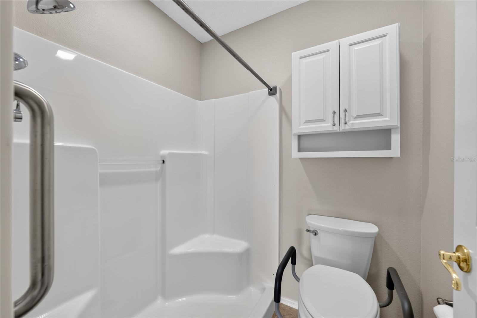 PRIMARY BATH - Close-up view shows details of the separate toilet and bathing area.