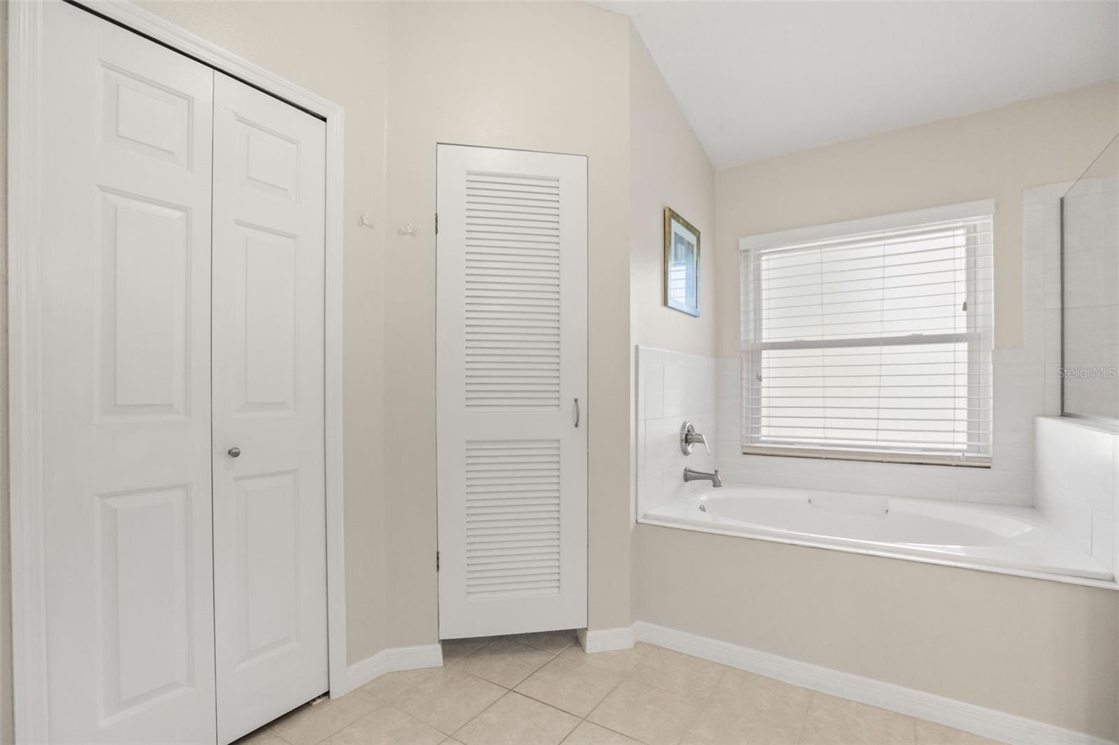 Primary ensuite garden tub with private restroom