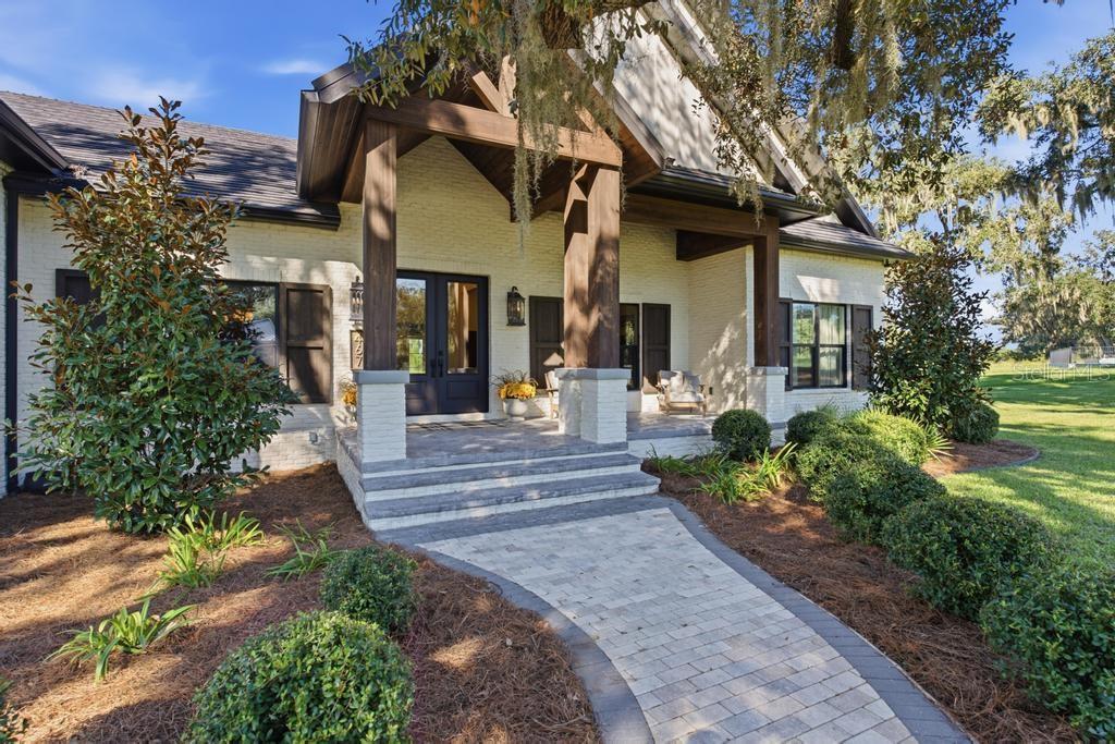 Brick walkway leading to front porch with large sitting area with easy to clean epoxy floors!