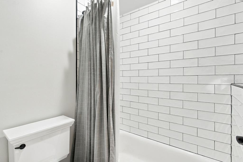 Tub and shower combo with tile accent wall