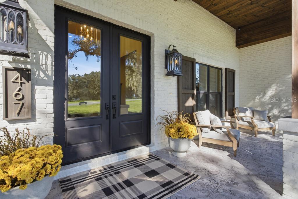 Charming covered porch ... Love this custom double door entrance!