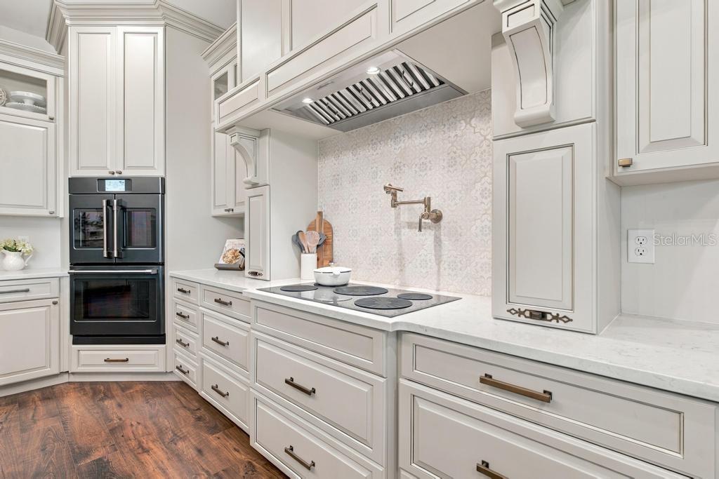 Kitchen with handmade tile backsplash and convenient pot filler