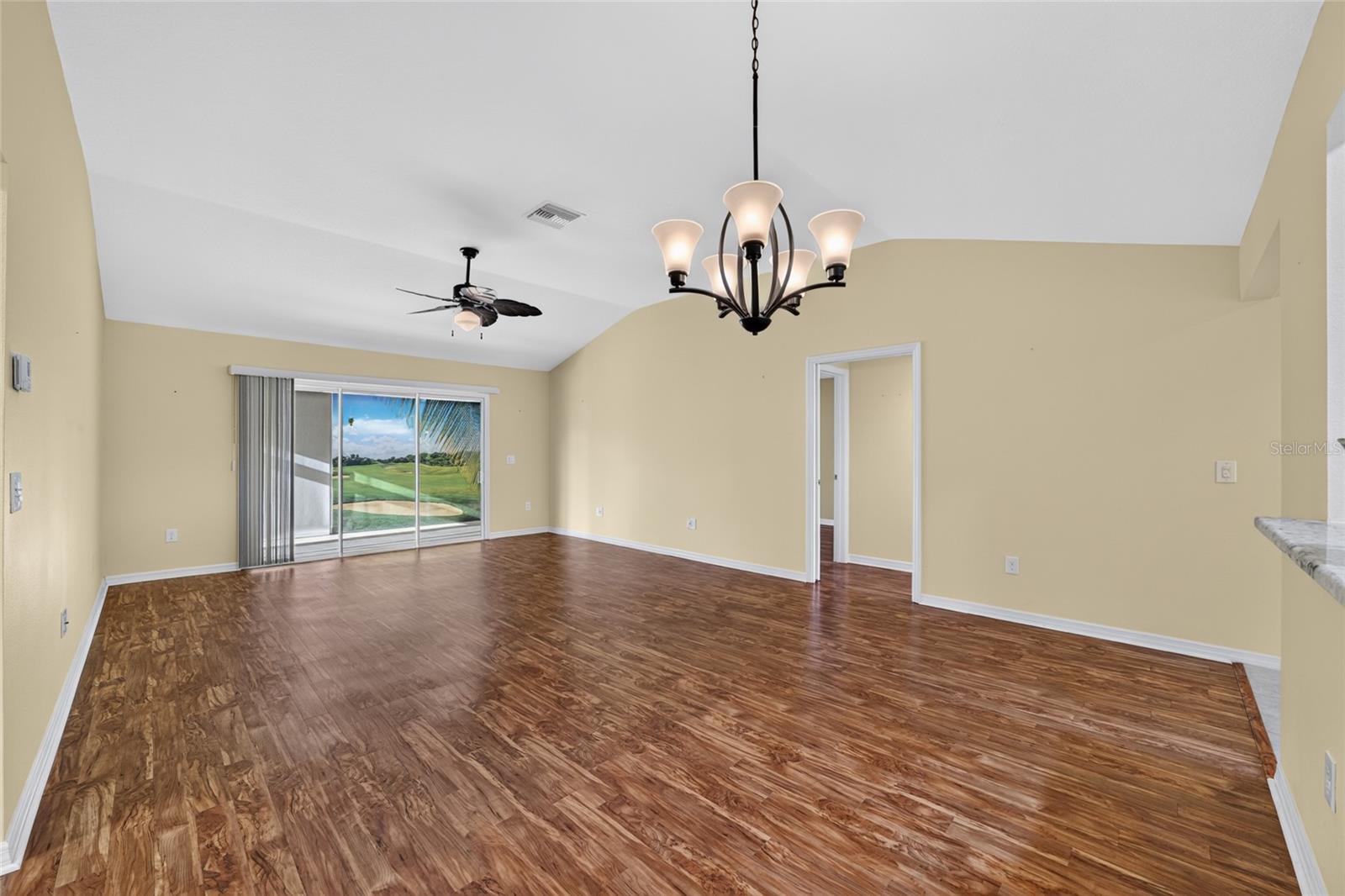 Glass slider doors from living room to glass enclosed florida room