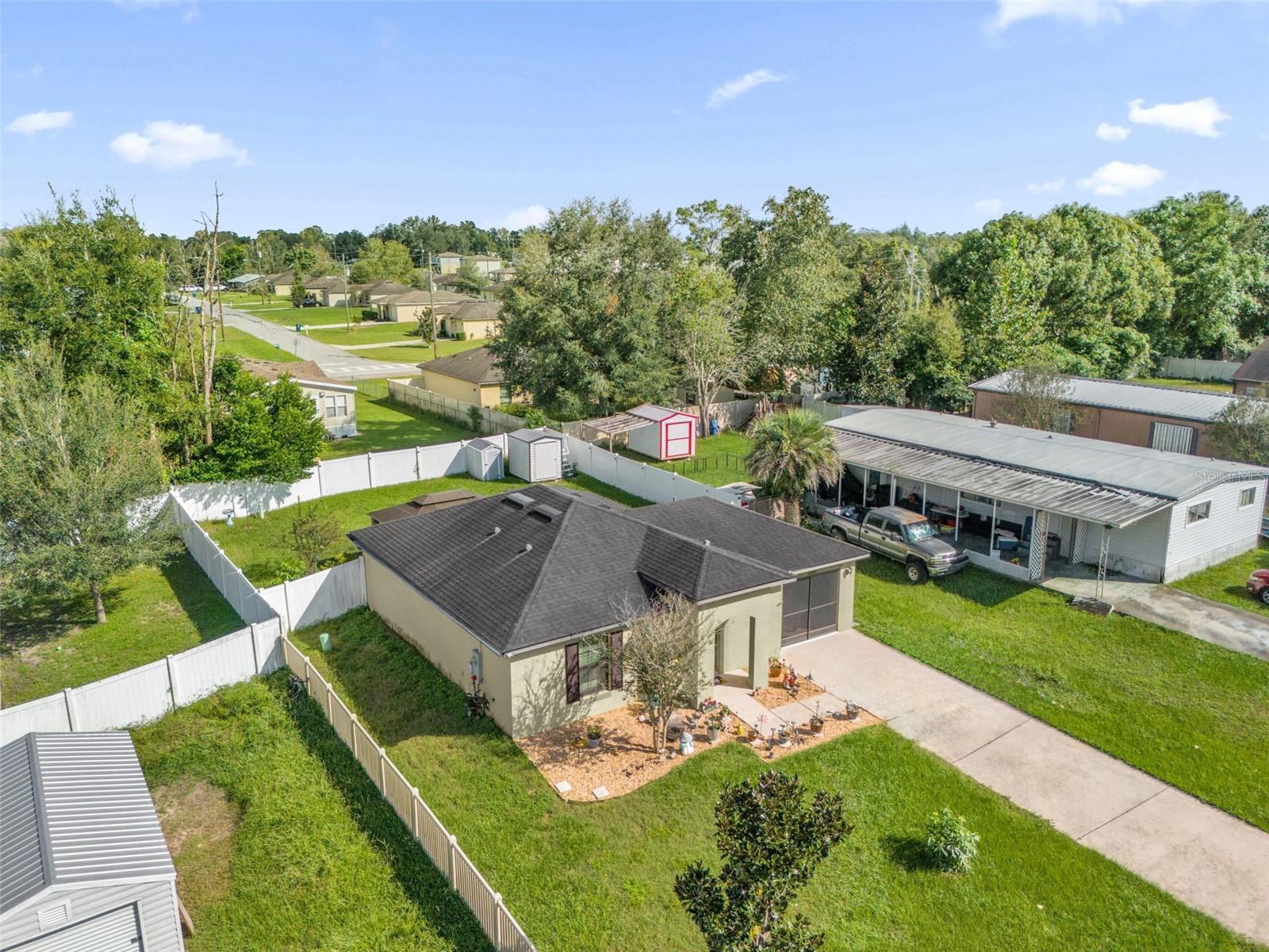Aerial view of home and fenced backyard