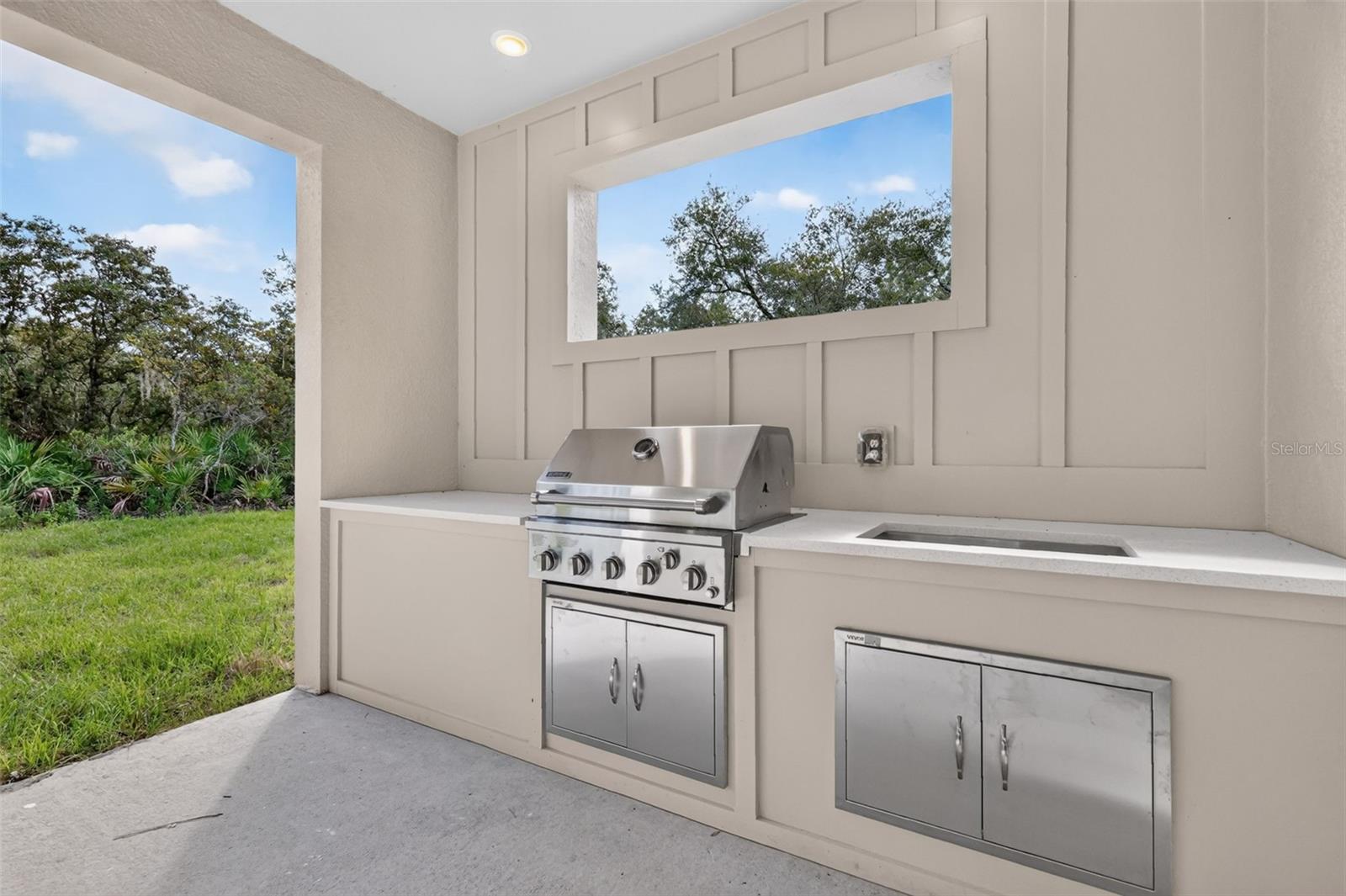 Outdoor grill and sink on back porch
