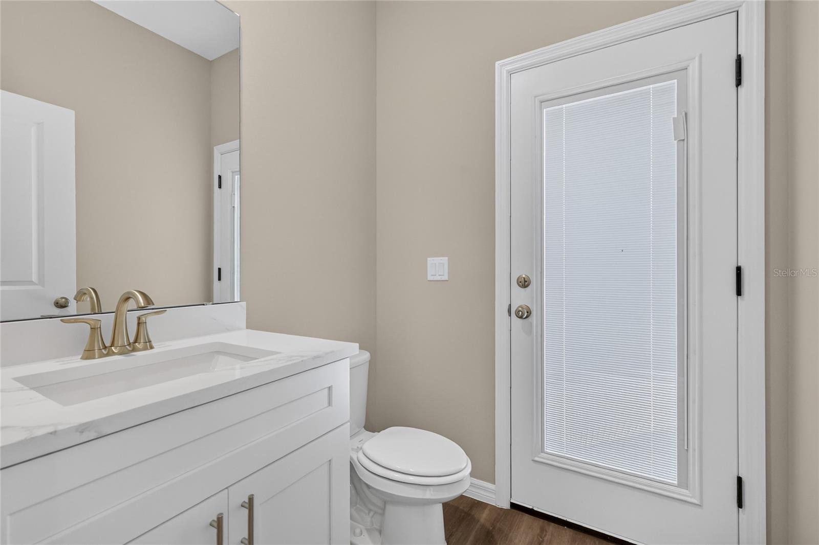 Half bath leads to back porch