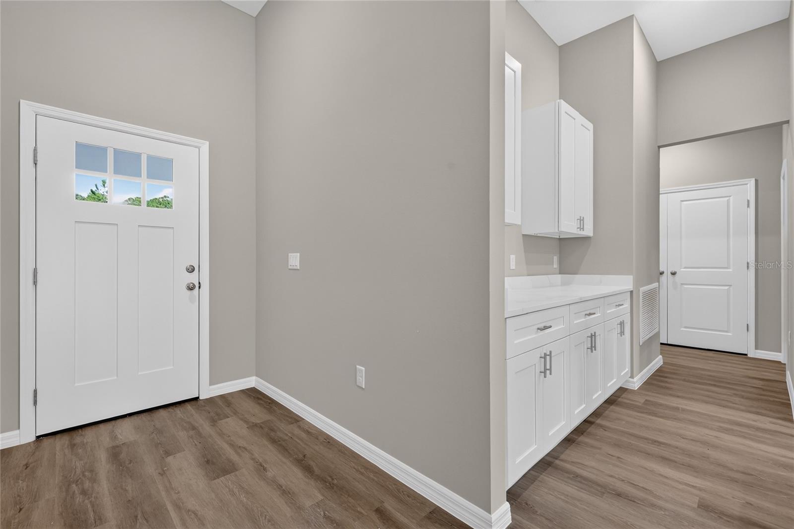 View of front door and part of kitchen