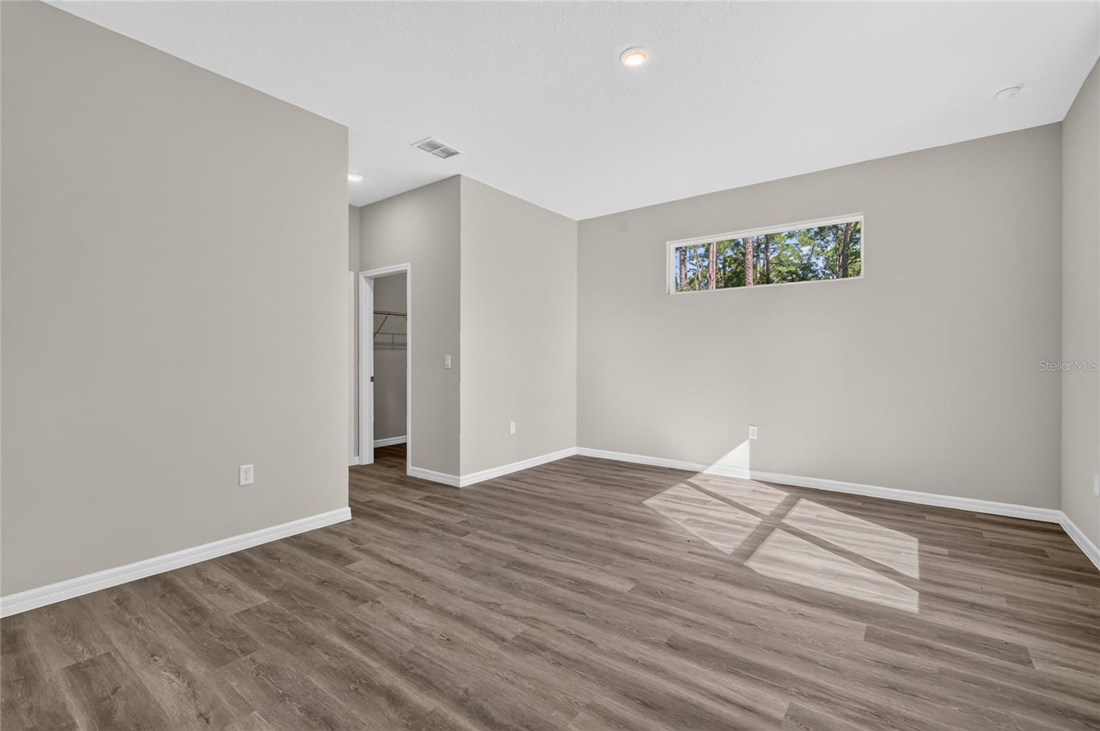 Primary bedroom with dual walk in closets