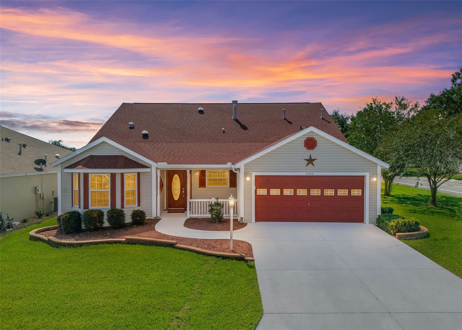 Twilight View with Decorative Pavers, Red Gravel and Low-Maintenance Shrubs. Twilight View with Decorative Pavers, Red Gravel and Low-Maintenance Shrubs.