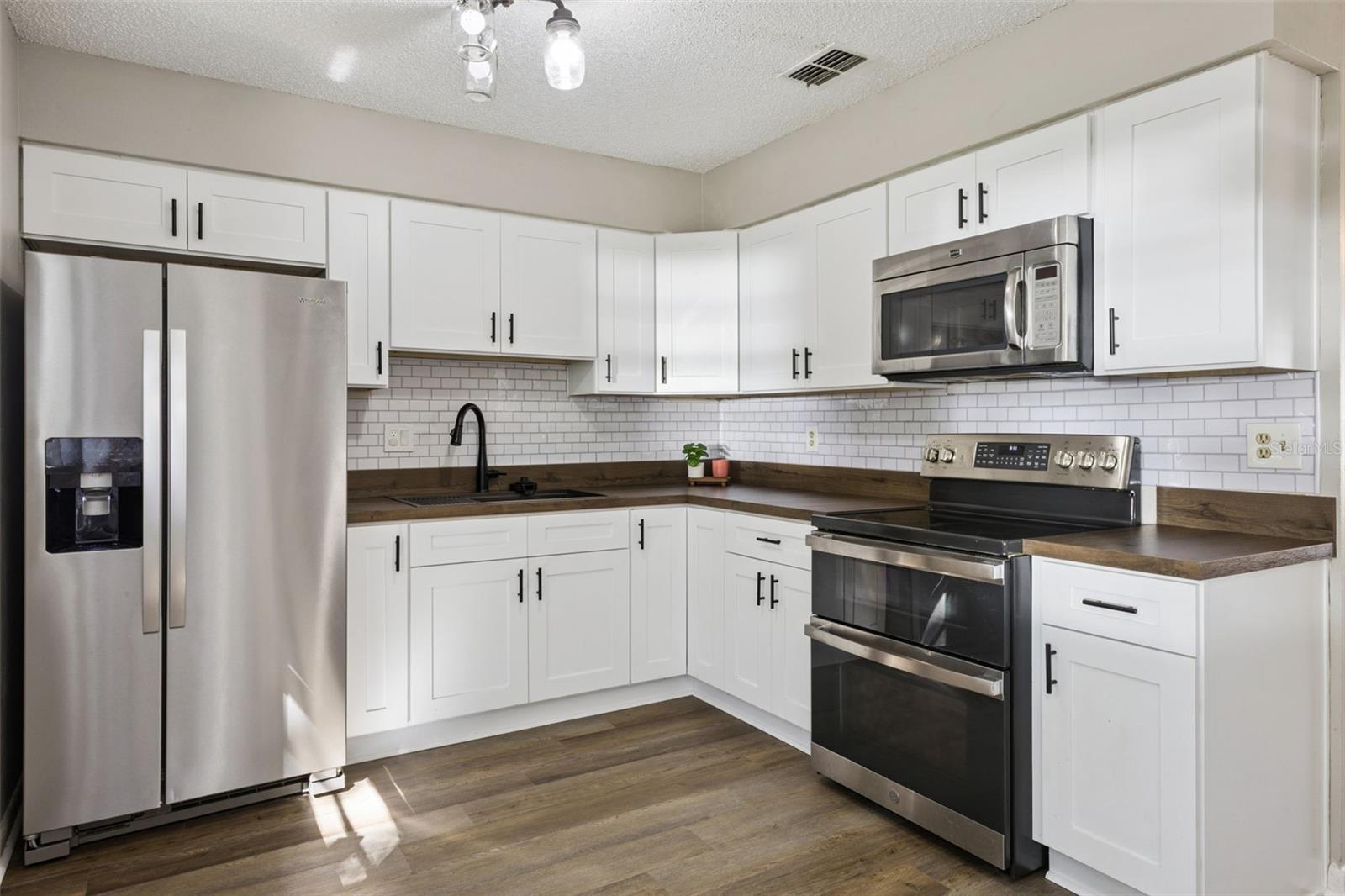 Kitchen has newer cabinets, counter, sink, faucet and appliances!