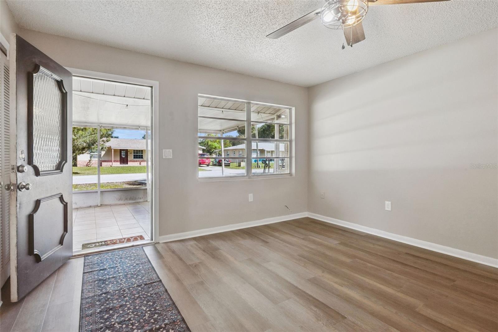 Living Room with ceiling fan and vinyl flooring.