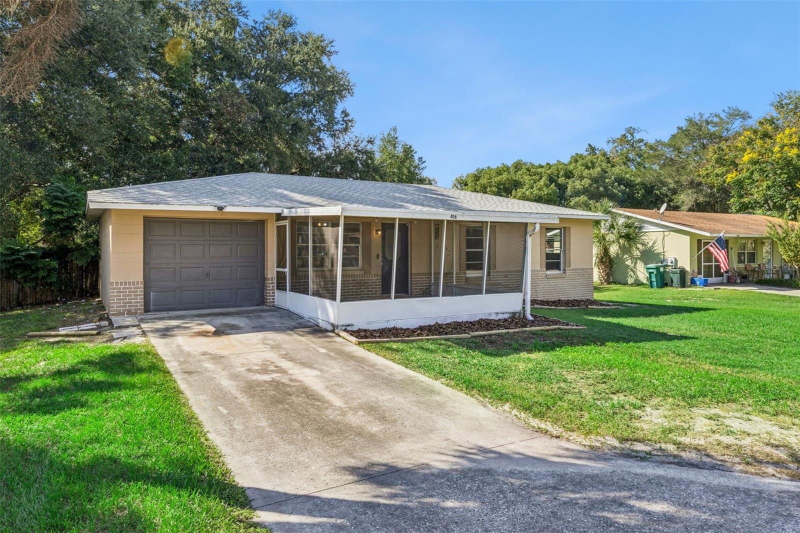 Driveway to 1-car garage.