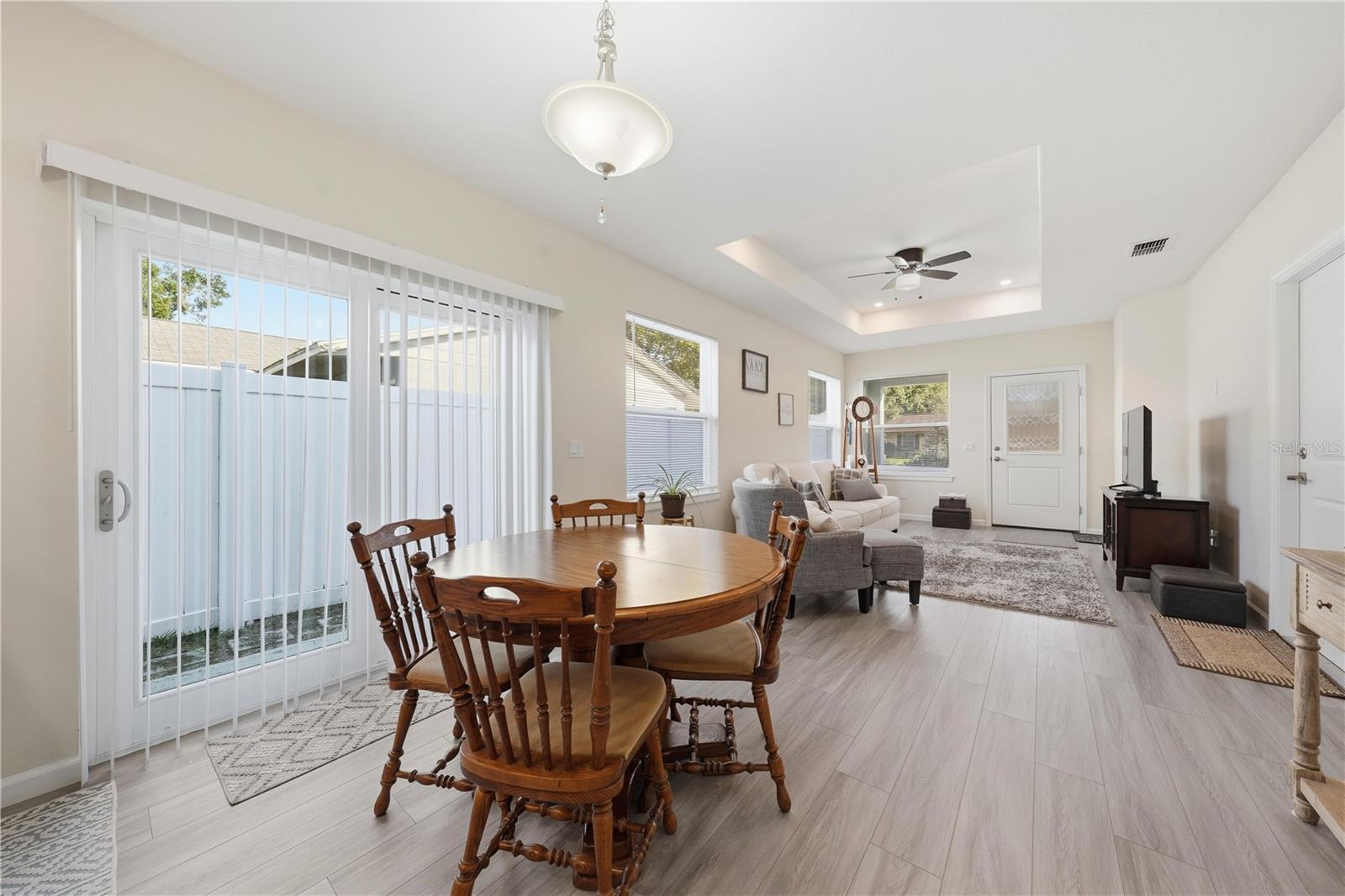 dining area and great room with sliding doors to the side yard