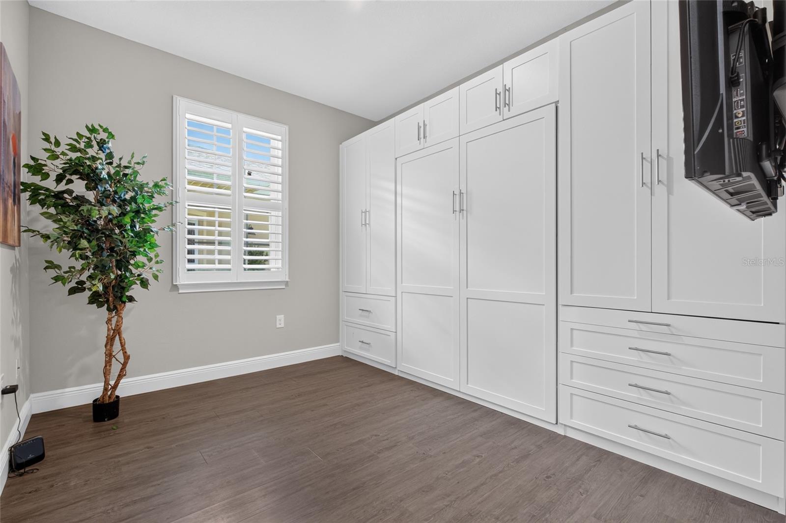 second bedroom. Murphy bed is available, custom cabinetry on right does not convey